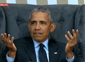 Barack Obama raises his hands with an incredulous expression.